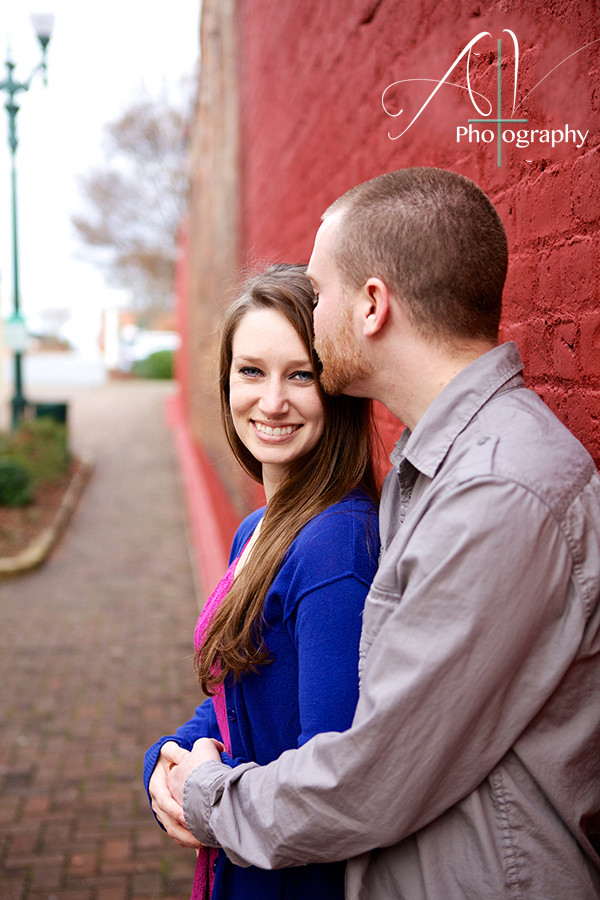 He kisses her head and holds her close during their Downtown Concord Engagement Session