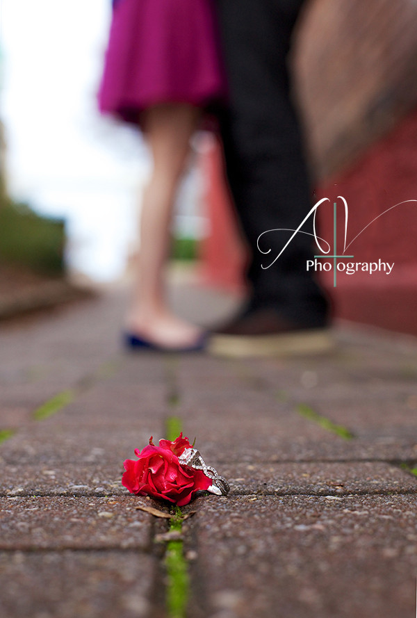 An artistic photograph of the engagement ring with a bokeh background during their Downtown Concord Engagement Session