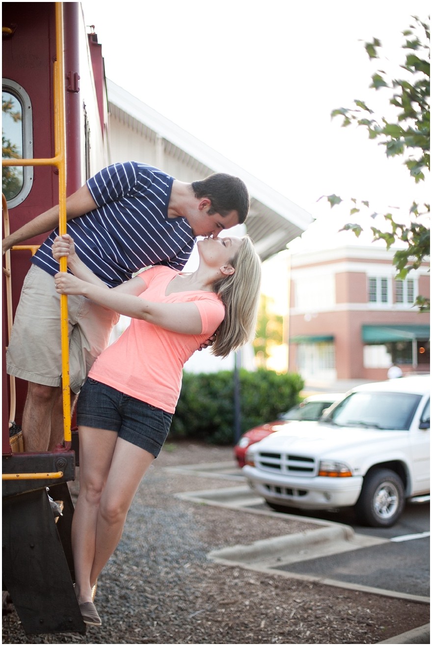 Downtown Matthews Charlotte engagement photos kissing on train