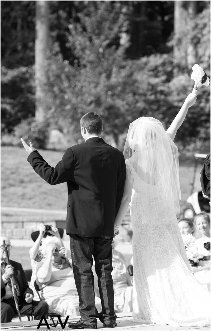 Bride and groom now pronounced husband and wife during the wedding ceremony at the summerfield amphitheater in North Carolina