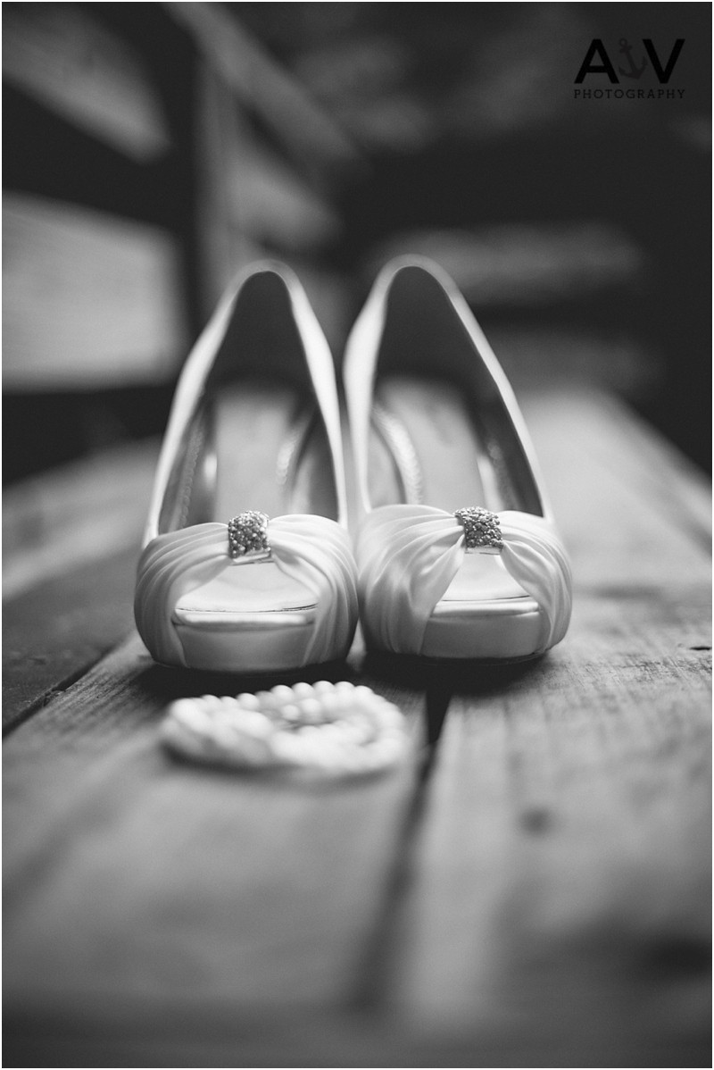 The Brides wedding shoes and pearl necklace with at the summerfield amphitheater in north carolina