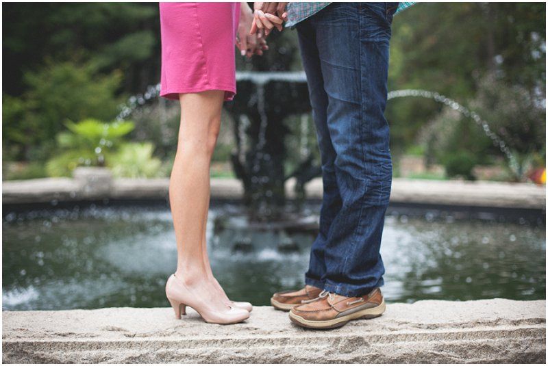 The shoes standing on the fountain at the Duke Gardens during the engagement session