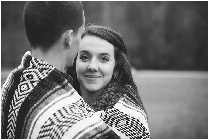 Bundled up in a blanket during the fall engagement session at reedy creek park in Charlotte North Carolina