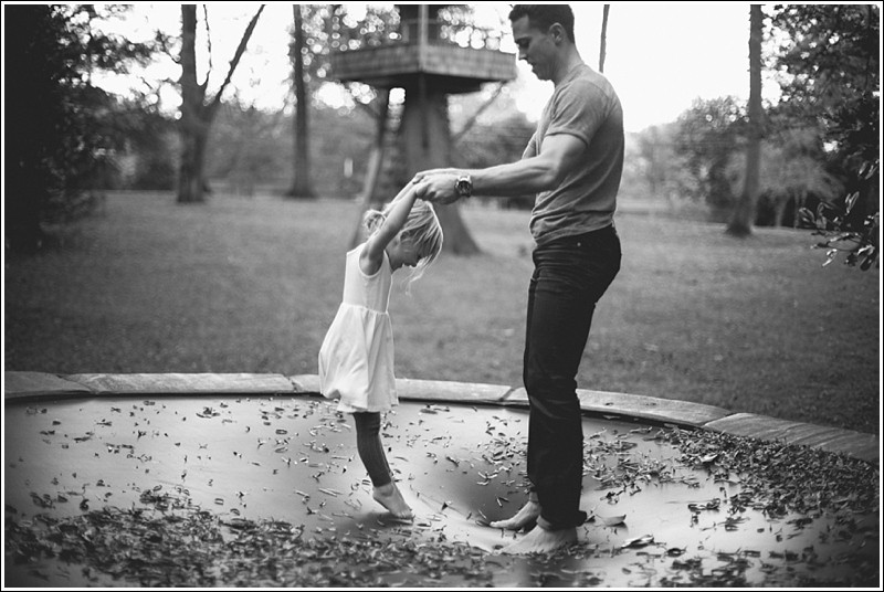 Father and daughter on the trampoline during the fall family portrait session in Charlotte nc