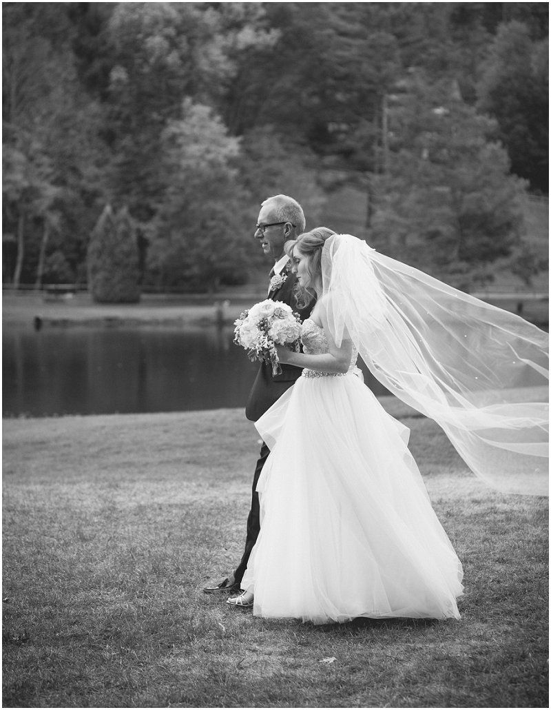 Bride and her father walking to the aisle at the Waterfront wedding at the chetola resort and spa in Blowing rock North Carolina