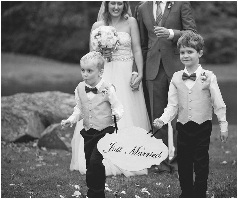 Ring bearers and aisle boys walking witht he just married sign during the Waterfront wedding at the chetola resort and spa in Blowing rock North Carolina