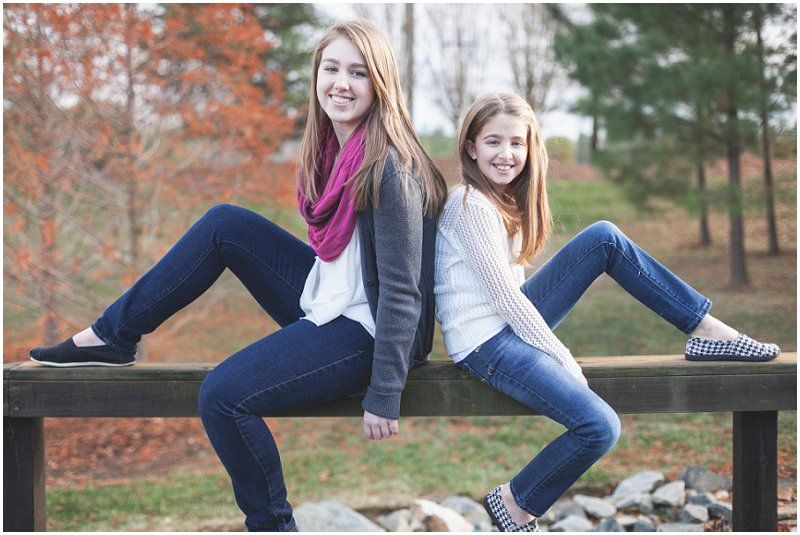 the sisters sitting back to back during the Charlotte north carolina fall family photography session