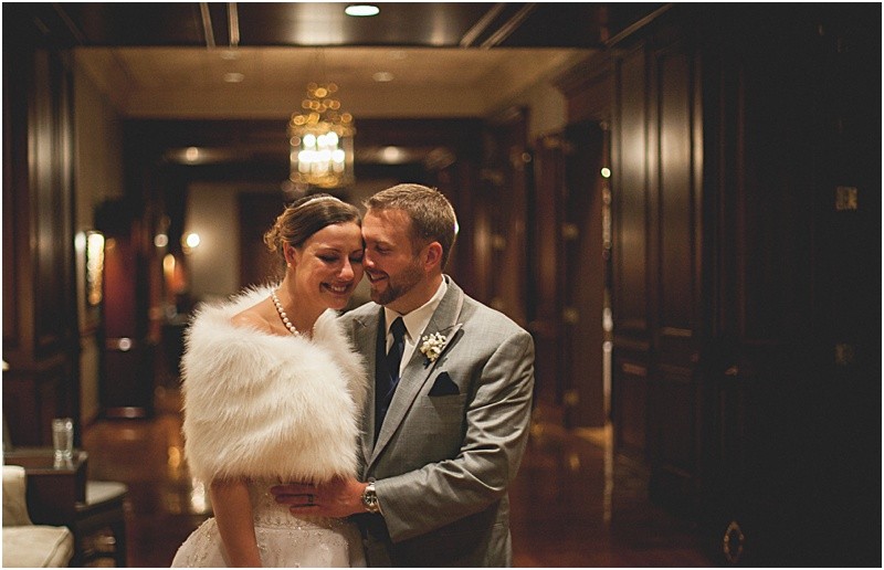 Romantic Classic look with the bride wearing a stylish fur wrap in the cold during the High Point North Carolina Wedding at First Baptist Church High Point and high point country club at Emerywood