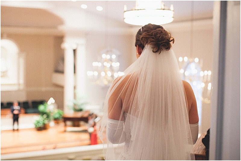 Bride overlooking the ceremony after the ceremony during the sparkler exit with a fur wrap during the High Point North Carolina Wedding at First Baptist Church High Point and high point country club at Emerywood