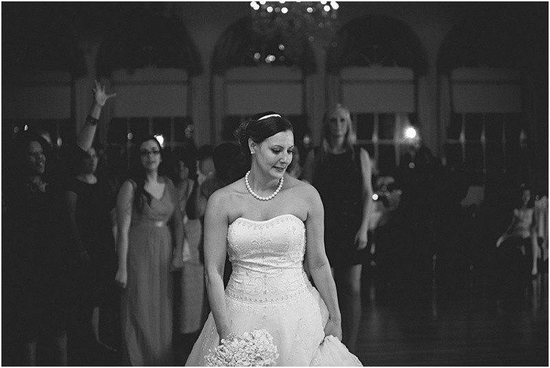 Throwing the bouquet during the sparkler exit with a fur wrap during the High Point North Carolina Wedding at First Baptist Church High Point and high point country club at Emerywood
