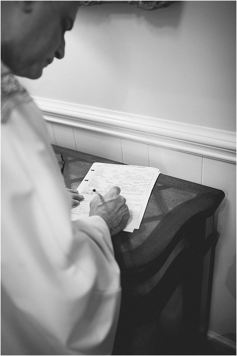 Signing the marriage license at the charlotte duke mansion wedding reception