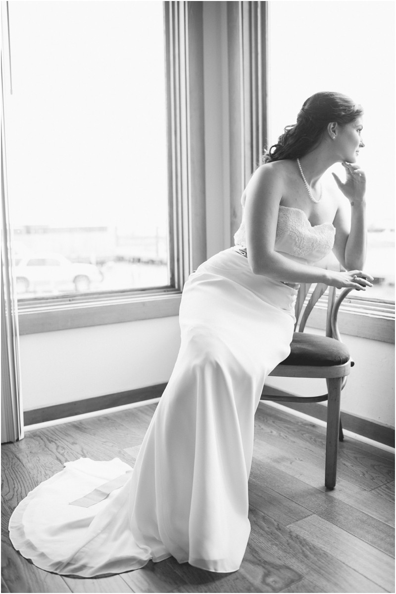 Her dress in a seat at the Charleston Yacht Club during a destination wedding in Charleston South Carolina near the ocean