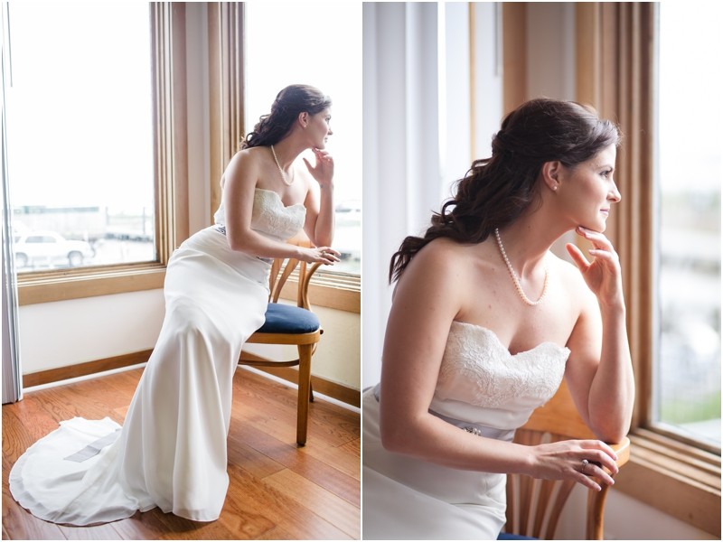 The bride looking out the window at the Charleston Yacht Club during a destination wedding in Charleston South Carolina near the ocean