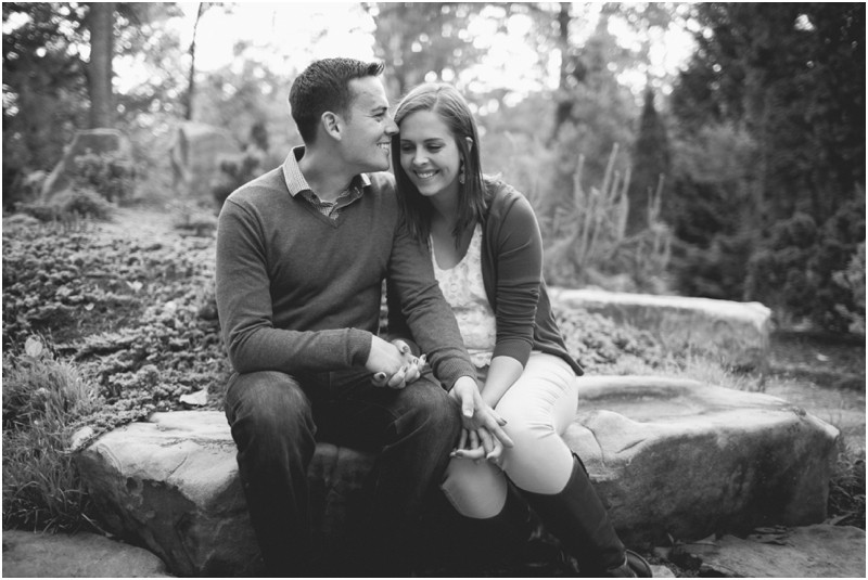 laughing and love Military camo uniform during the engagement session at freedom park and the uncc botanical gardens