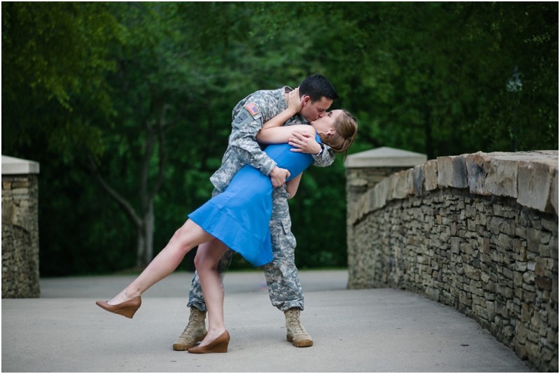 bend over kissing Military camo uniform during the engagement session at freedom park and the uncc botanical gardens