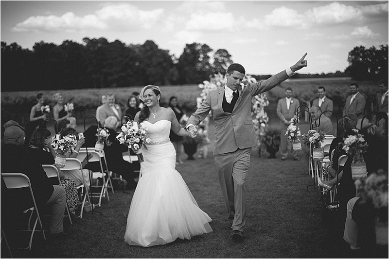 Celebrate walking down the aisle during the vineyard wedding at the Hinnant Family Vineyard in Pine Level Nc near Raleigh