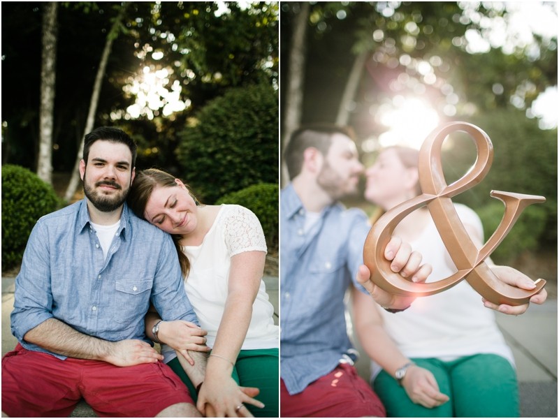 Holding an ampersand sign at the Three River Greenway in Columbia South Carolina During their engagement session