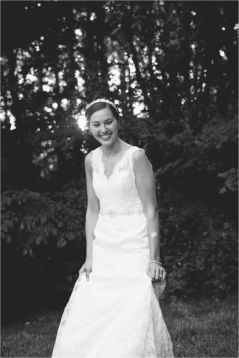 holding her dress while twirling it and laughing at the Jetton park bridal portrait session in lake norman north carolina