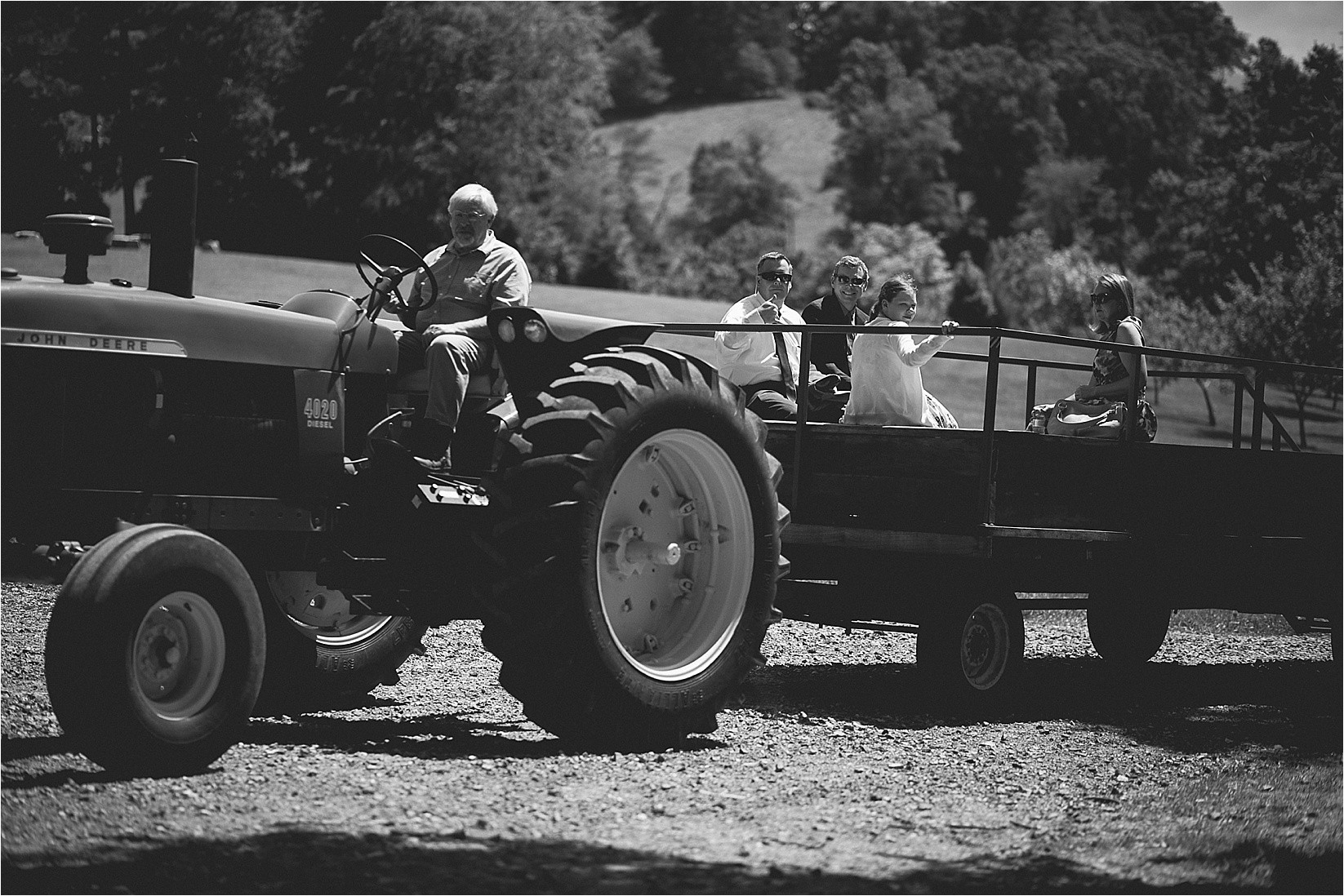 Pulling people on the tractor at Caroline and Evans mountain wedding at yesterday spaces in asheville leicester north caroline