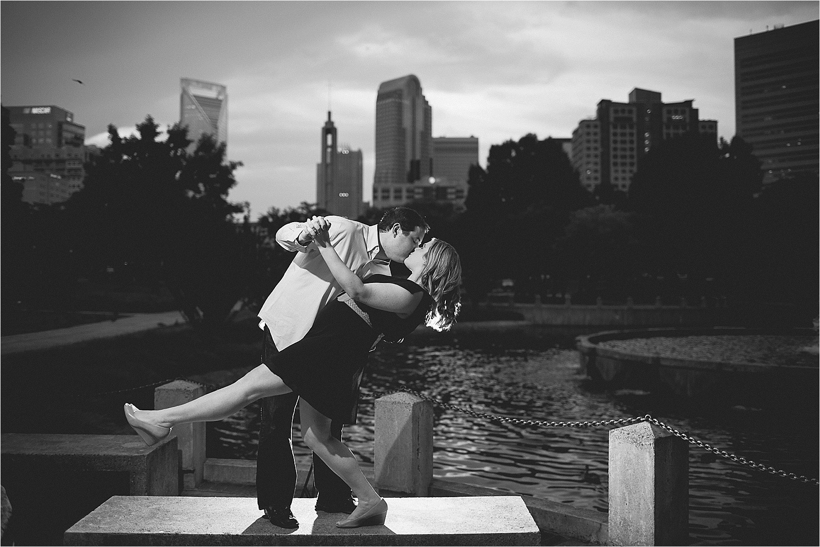 black and white backlight with the charlotte skyline at Catherine & Jordan's engagement session at freedom park and marshall park in Charlotte North Carolina