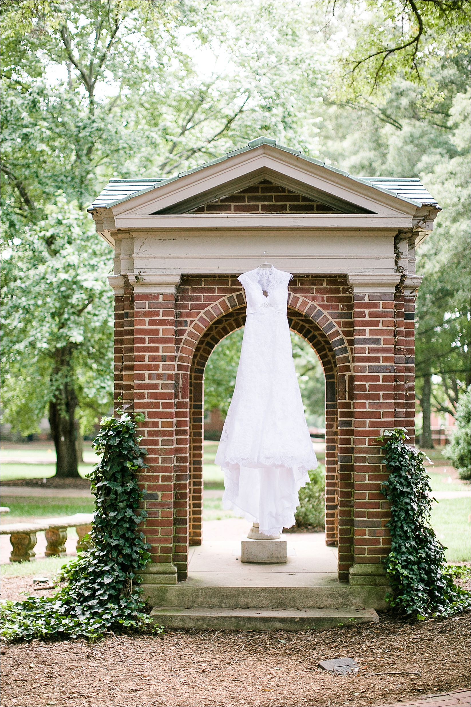 Dress hanging on the fountain at the davidson college chapel wedding in Davidson north Carolina and the Charles mack citizen center wedding and reception