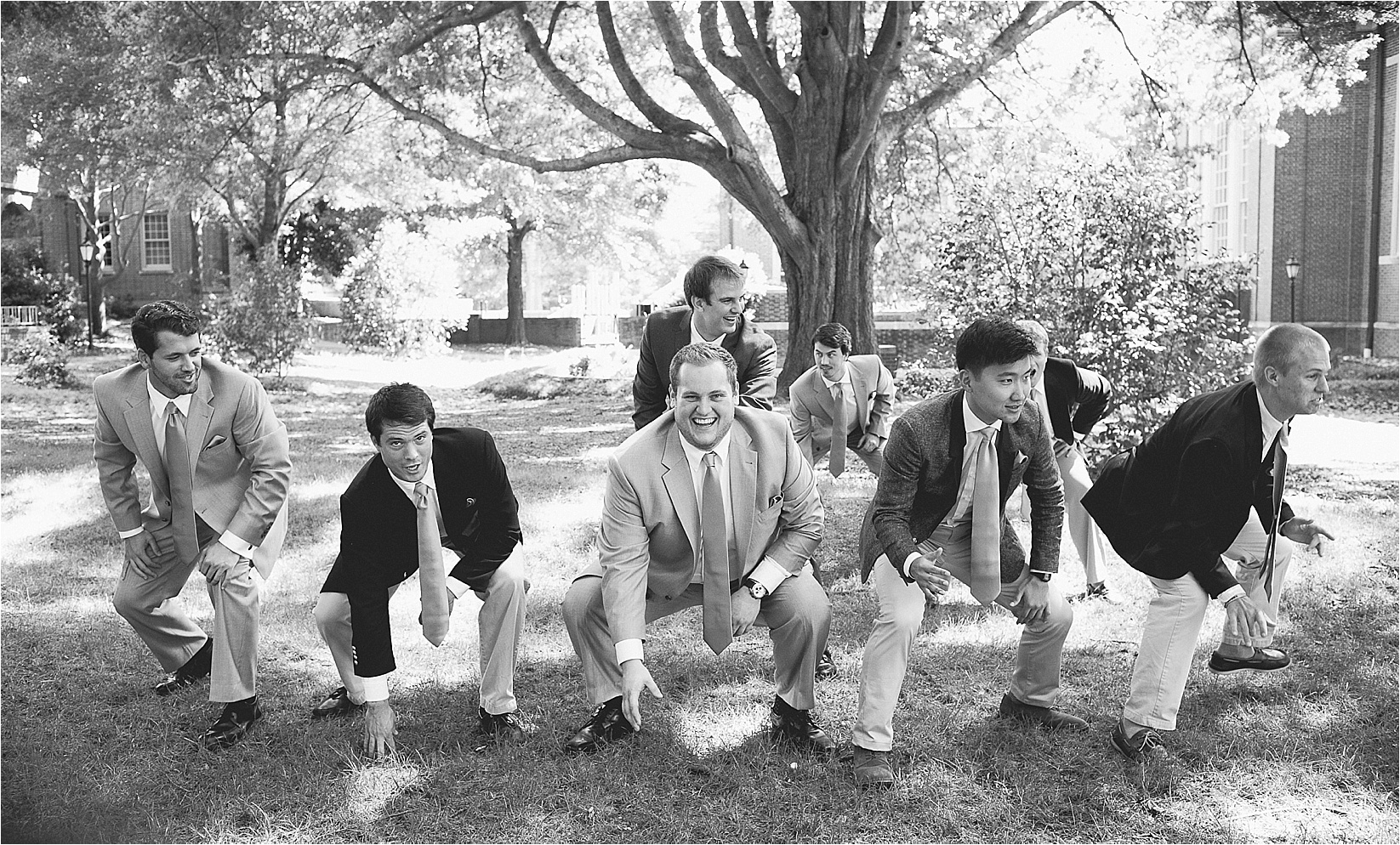 groomsmen playing footballat the davidson college chapel wedding in Davidson north Carolina and the Charles mack citizen center wedding and reception