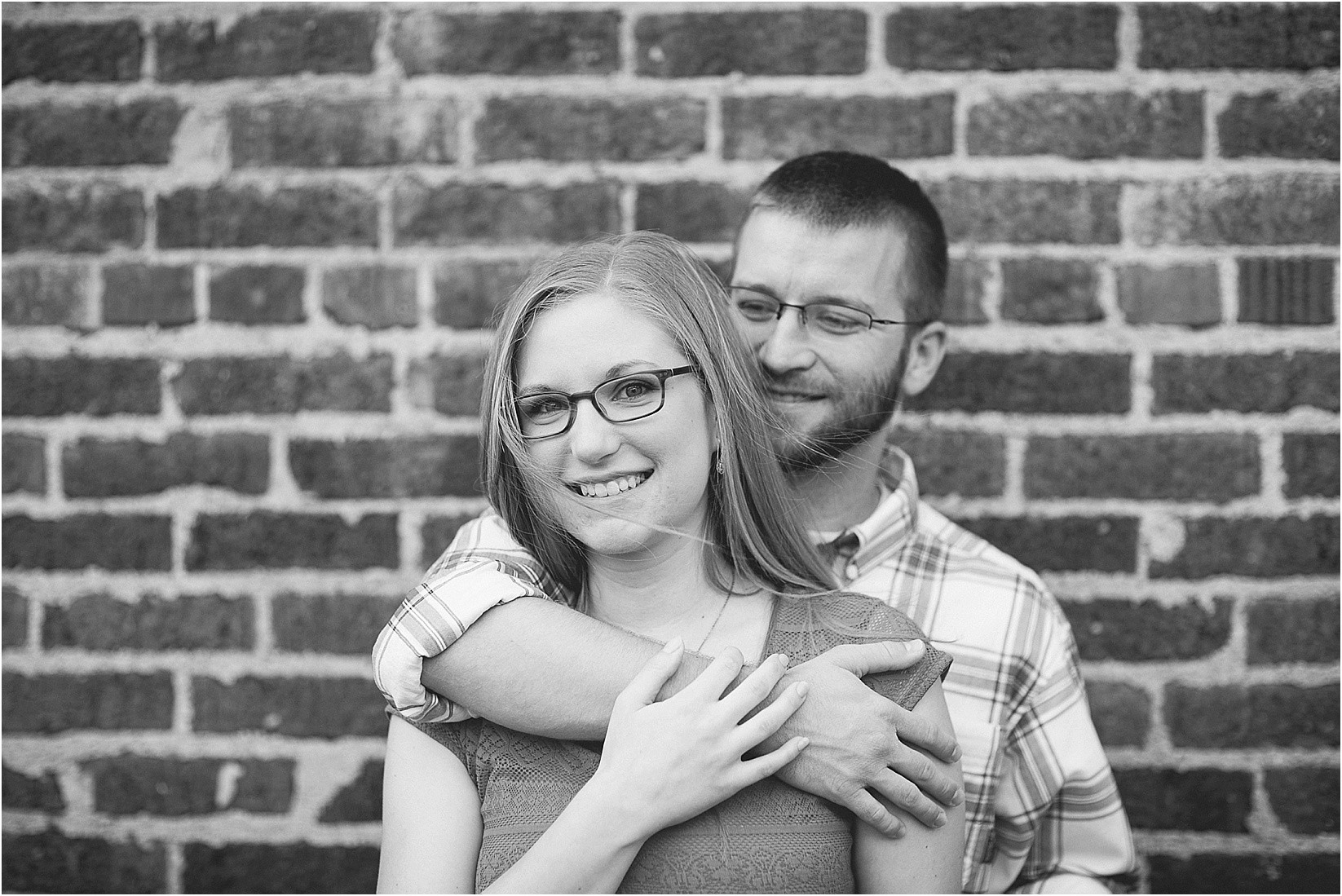 Holding behind her during Andria & Matts Mount Pleasant engagement session in downtown mount pleasant nc