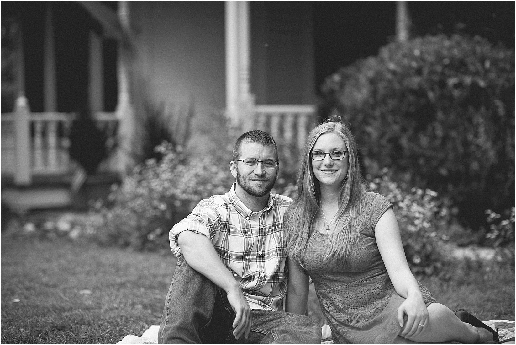 sitting in the grass during Andria & Matts Mount Pleasant engagement session in downtown mount pleasant nc