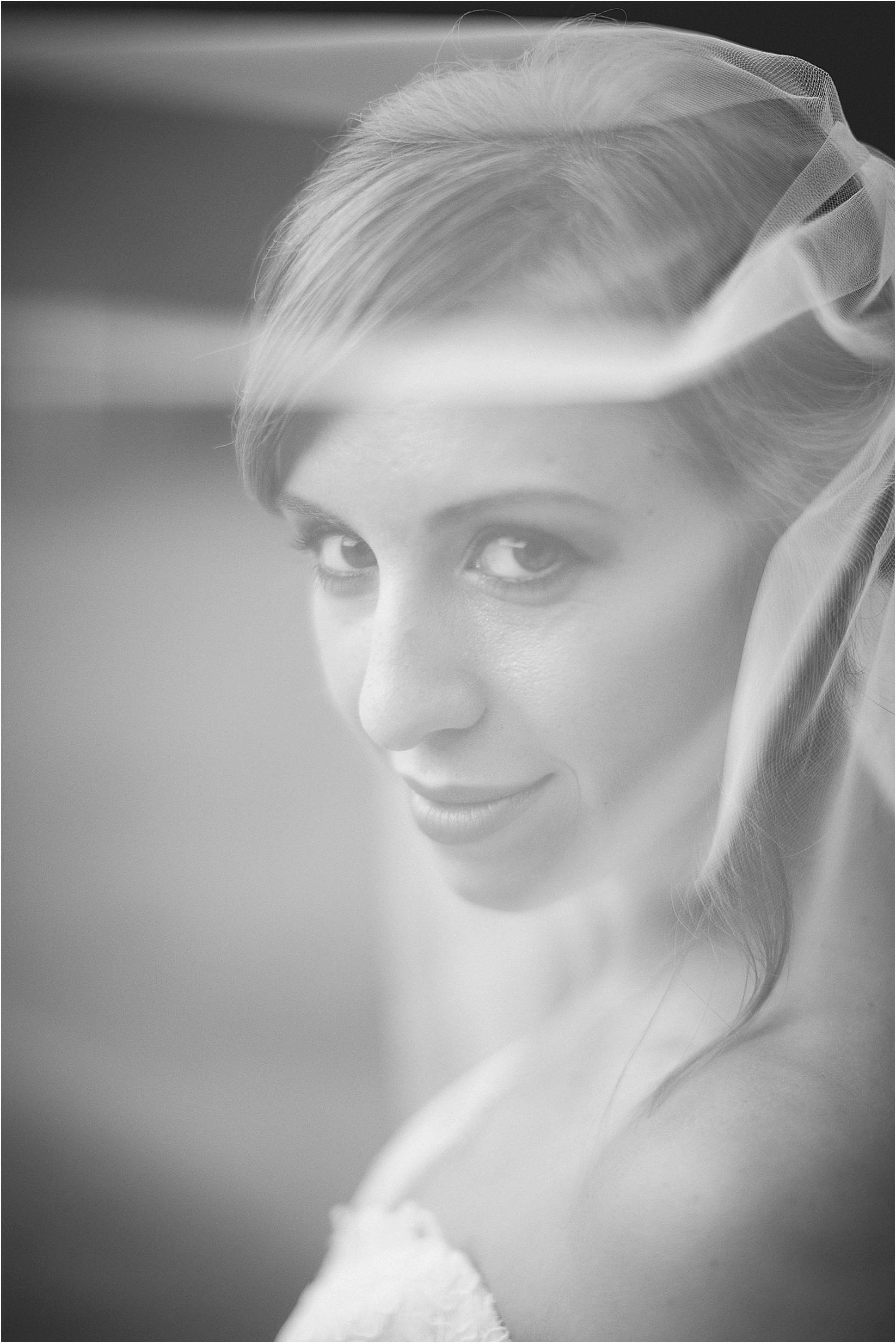 looking through the veil to the camera during anna's beaver dam bridal session in davidson north carolina nc