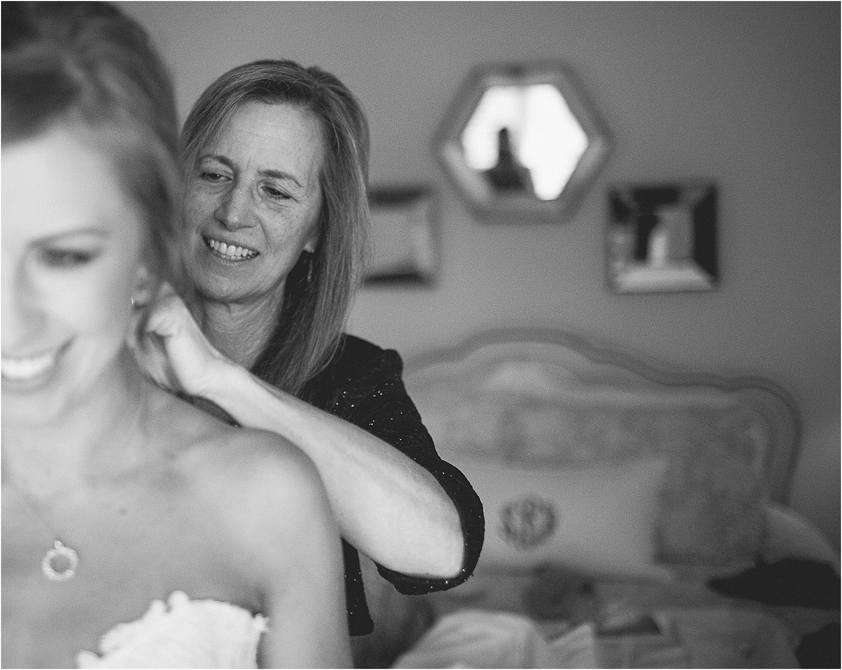 mom helping to put jewelry on during their wedding at the Historic Rural Hill wedding ceremony and reception in Huntersville nc