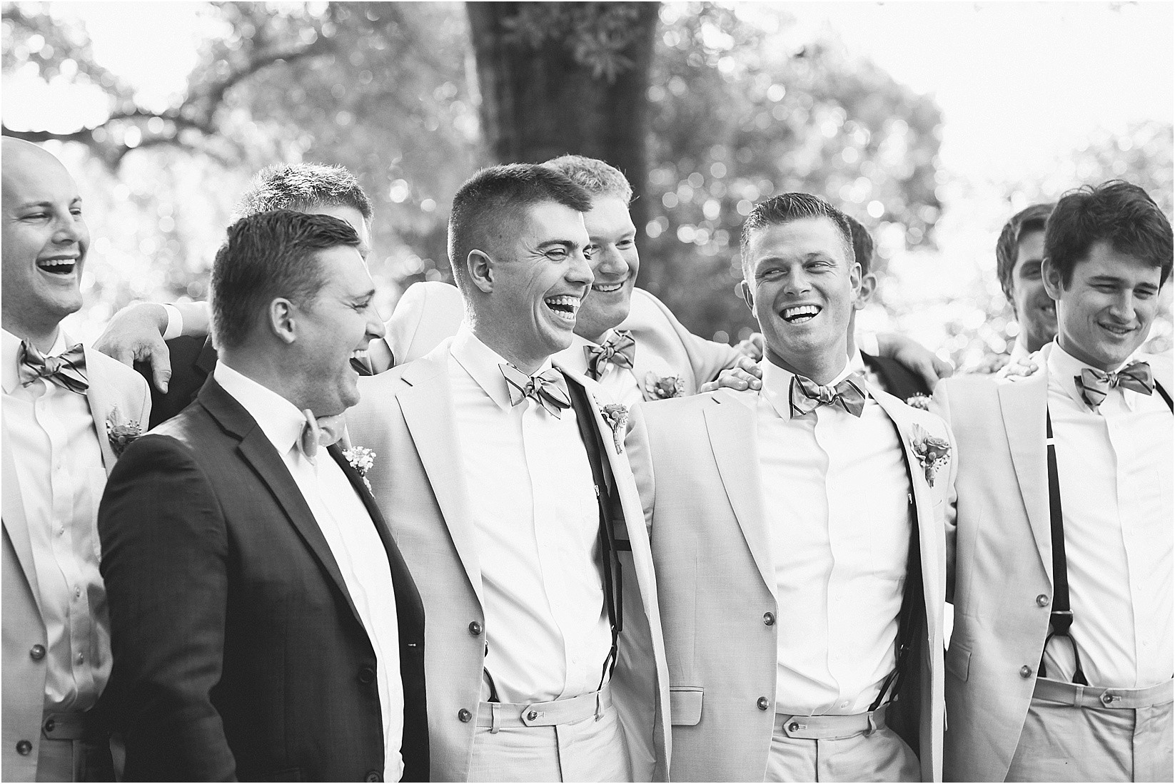 Groomsmen laughing during their wedding at the Historic Rural Hill wedding ceremony and reception in Huntersville nc