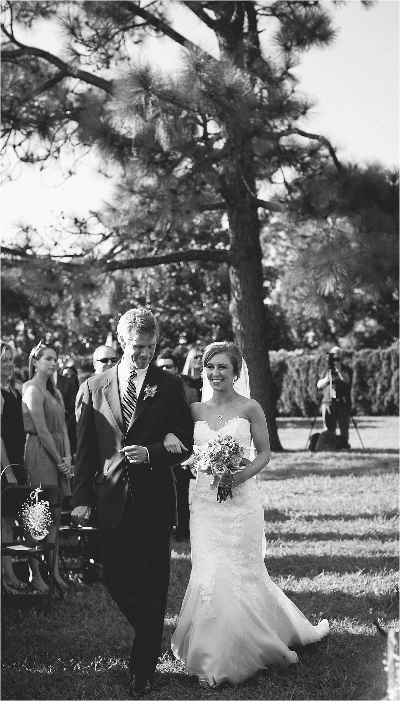 bride walking down with her father during their wedding at the Historic Rural Hill wedding ceremony and reception in Huntersville nc