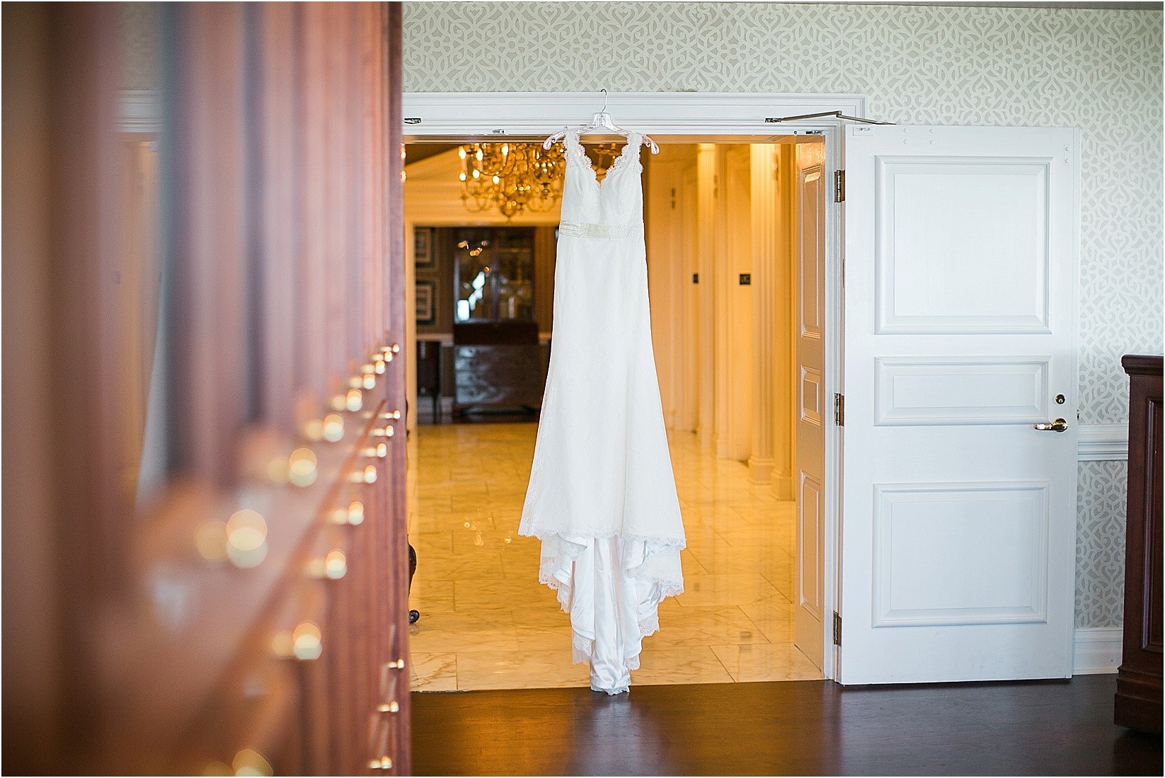 The dress hanging up in the hallway at the during the Charlotte City Club wedding in charlotte North Carolina