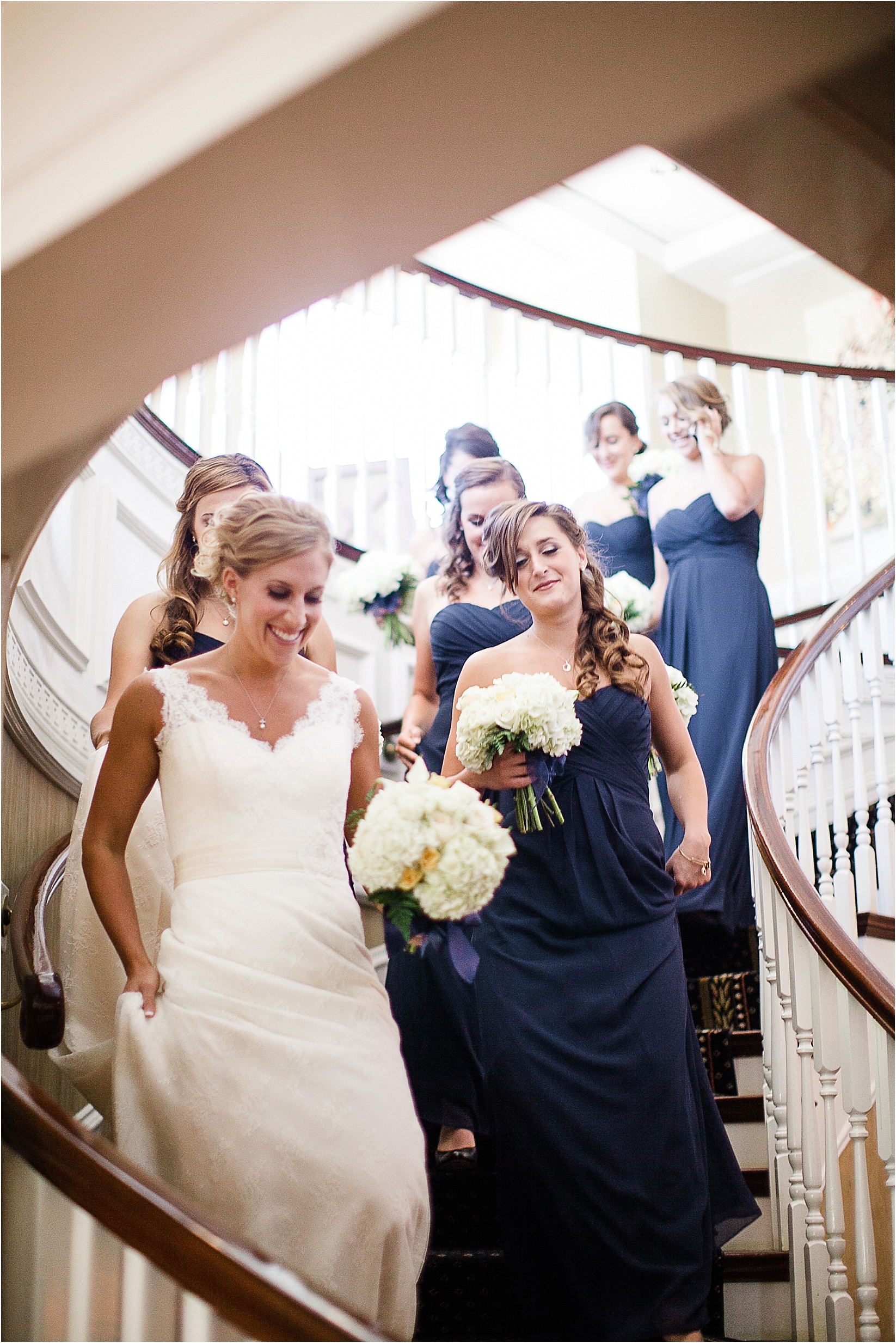 walking down the stairs during the Charlotte City Club wedding in charlotte North Carolina