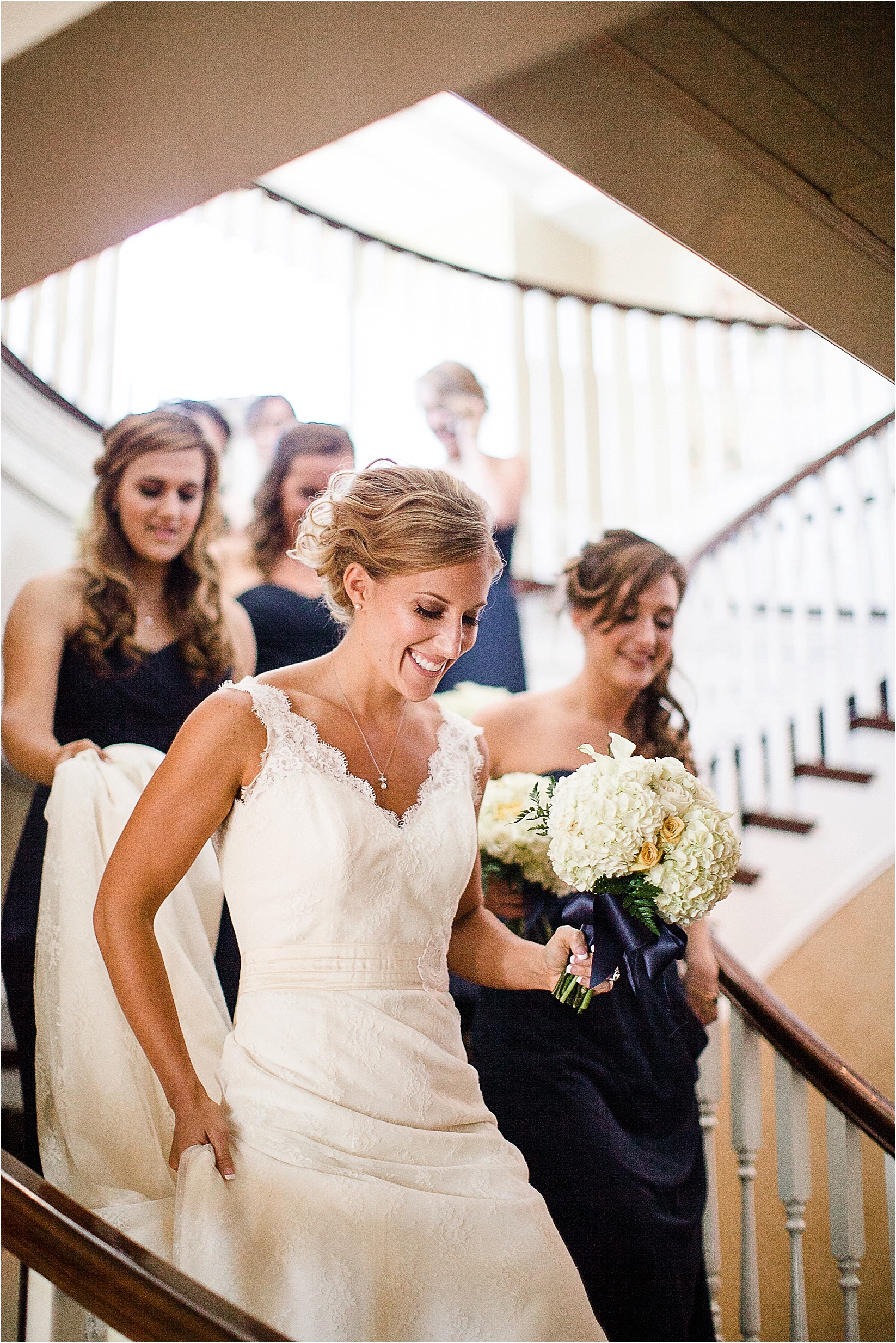 the ladies walking down the stairs during the Charlotte City Club wedding in charlotte North Carolina