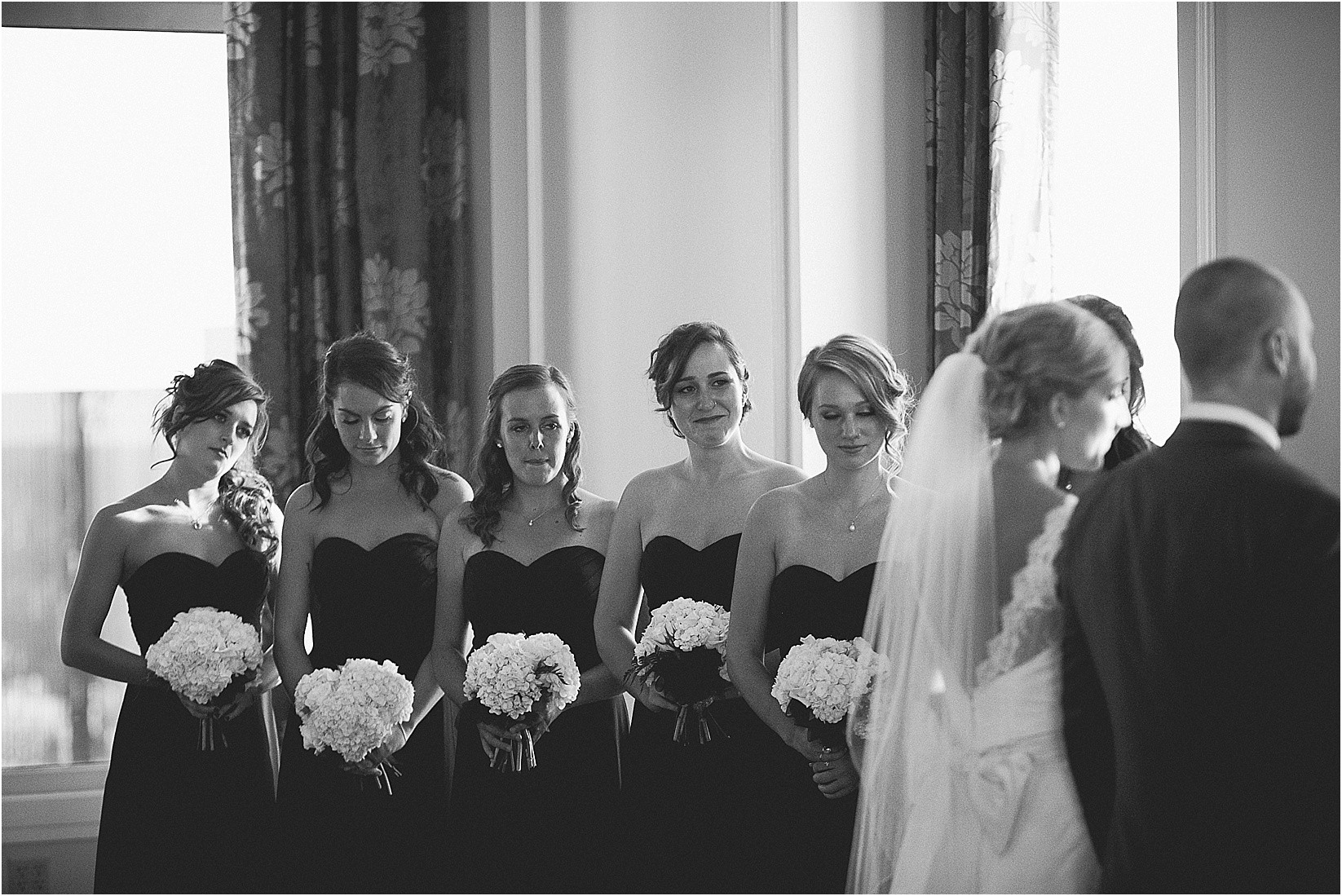 bridesmaids during the ceremony at the Charlotte City Club wedding in charlotte North Carolina