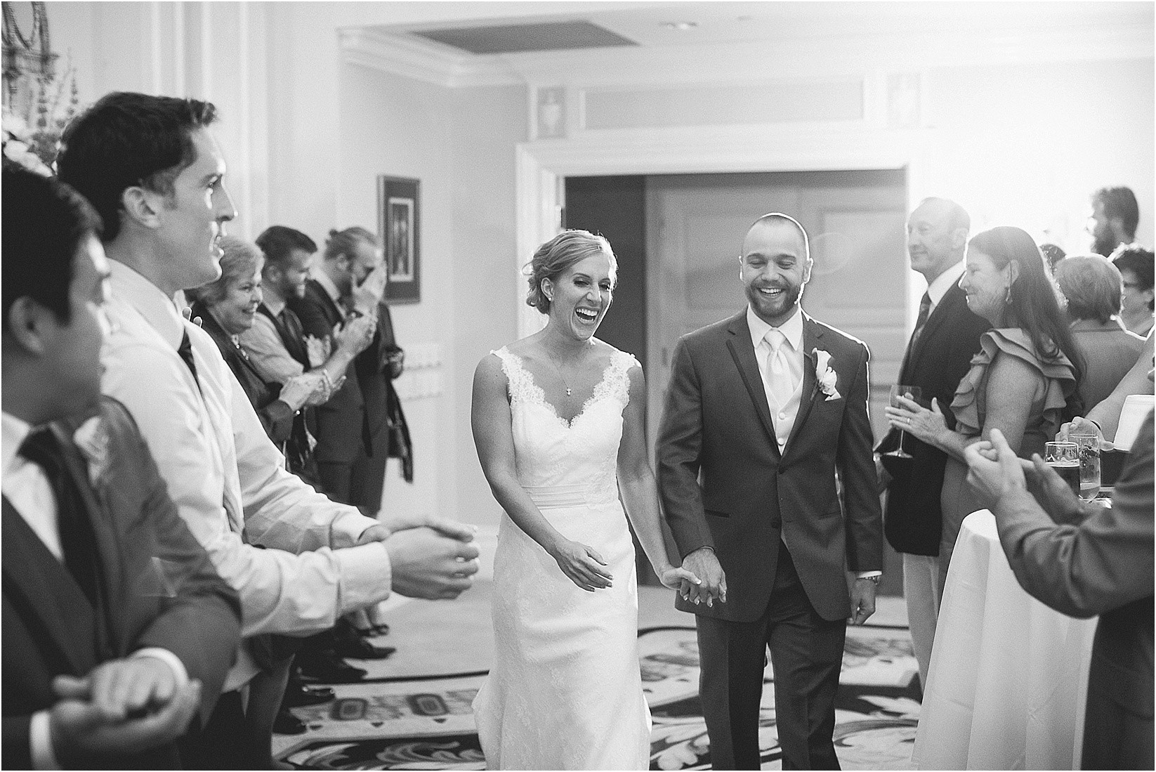 bride and groom entering into the reception at the Charlotte City Club wedding in charlotte North Carolina