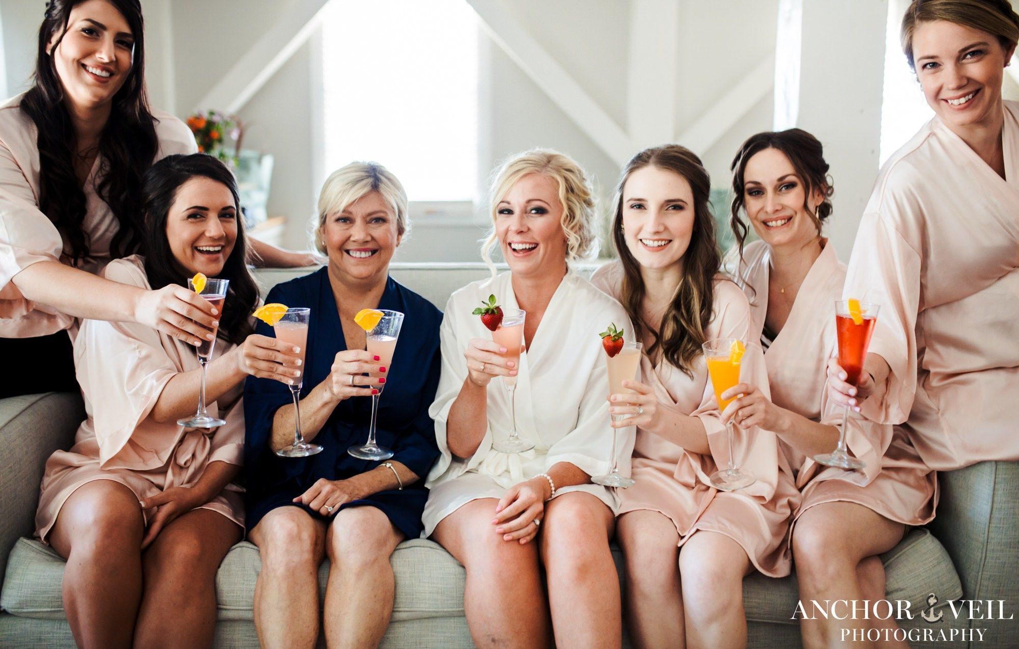 Bridal Party Sitting on couch with mimosas