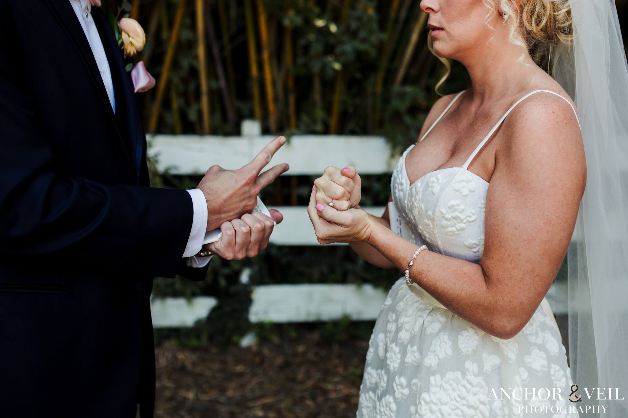 bride and groom playing rock paper scissors