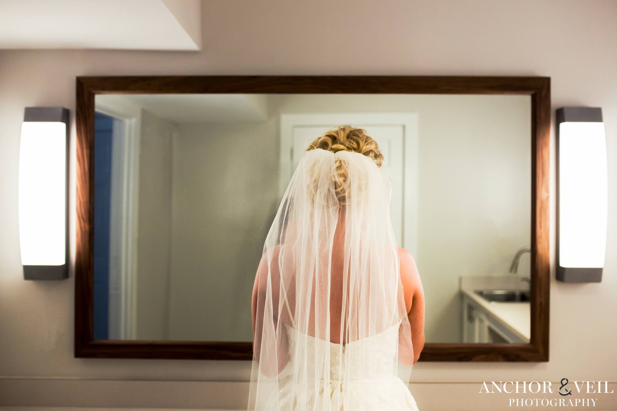 bride looking in mirror before the wedding