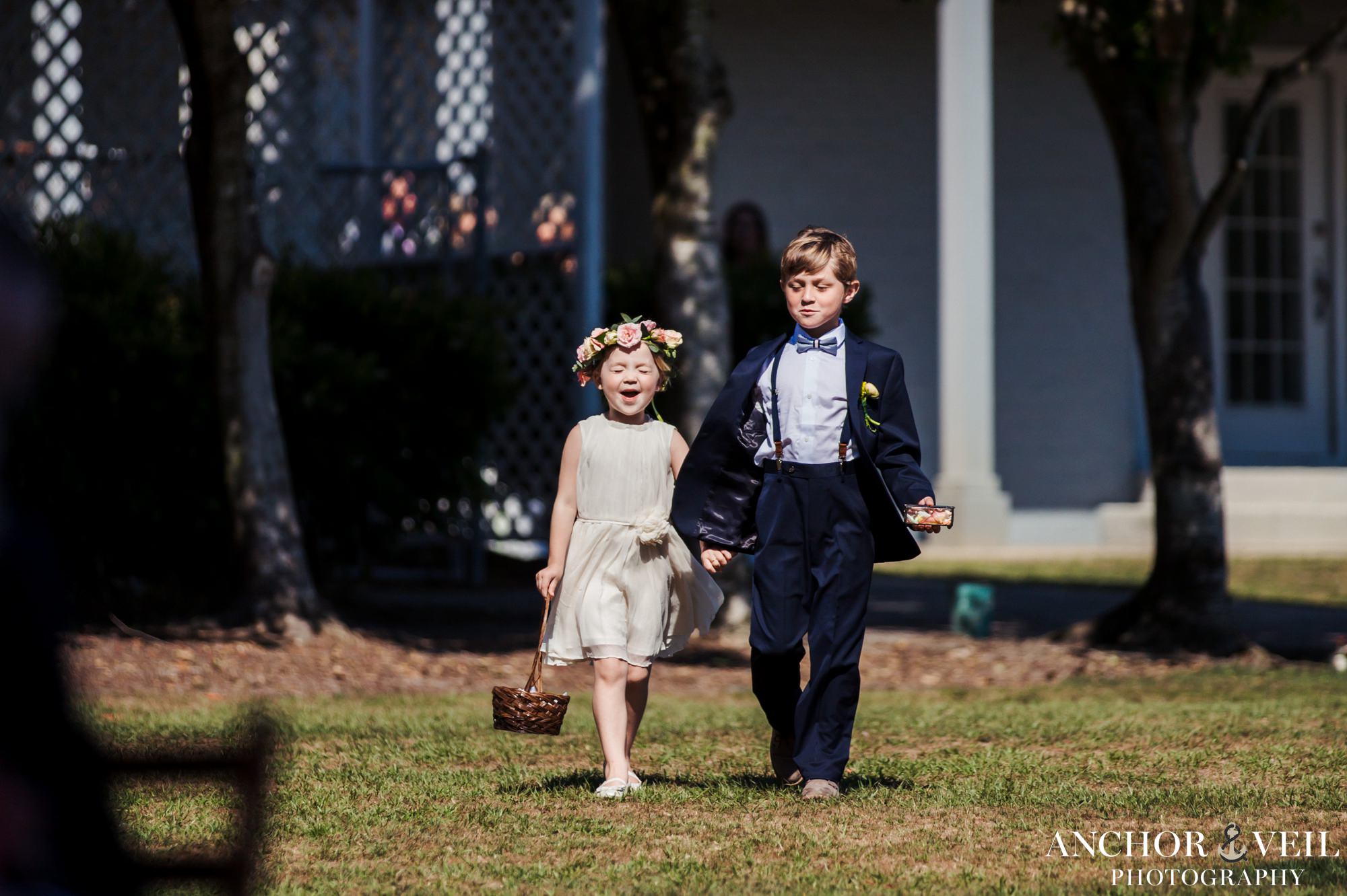 flower girl and ring bearer excited to walk down aisle
