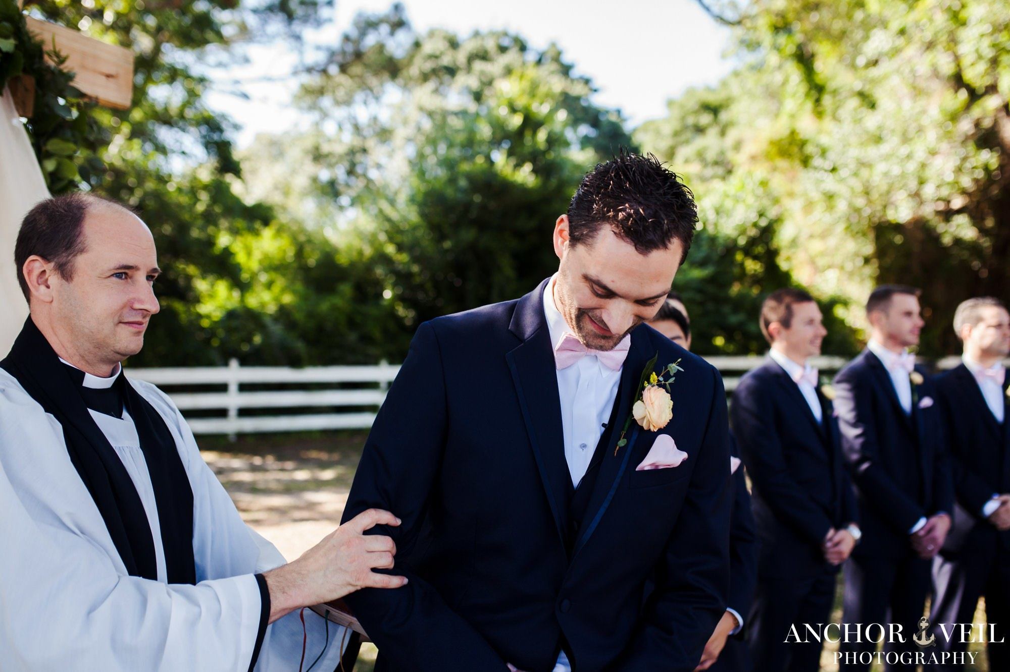 groom excited to see bride as she walks down aisle