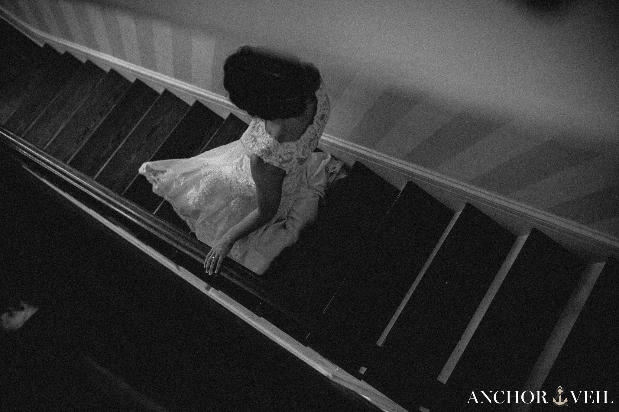 anticipation walking down the stairs in her dress during their Forsyth Park Wedding Elopement