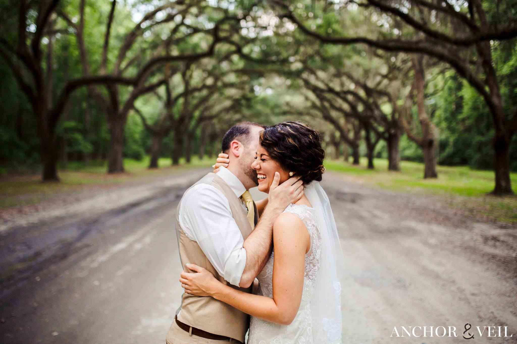 holding tight and whispering in her ear during their Forsyth Park Wedding Elopement