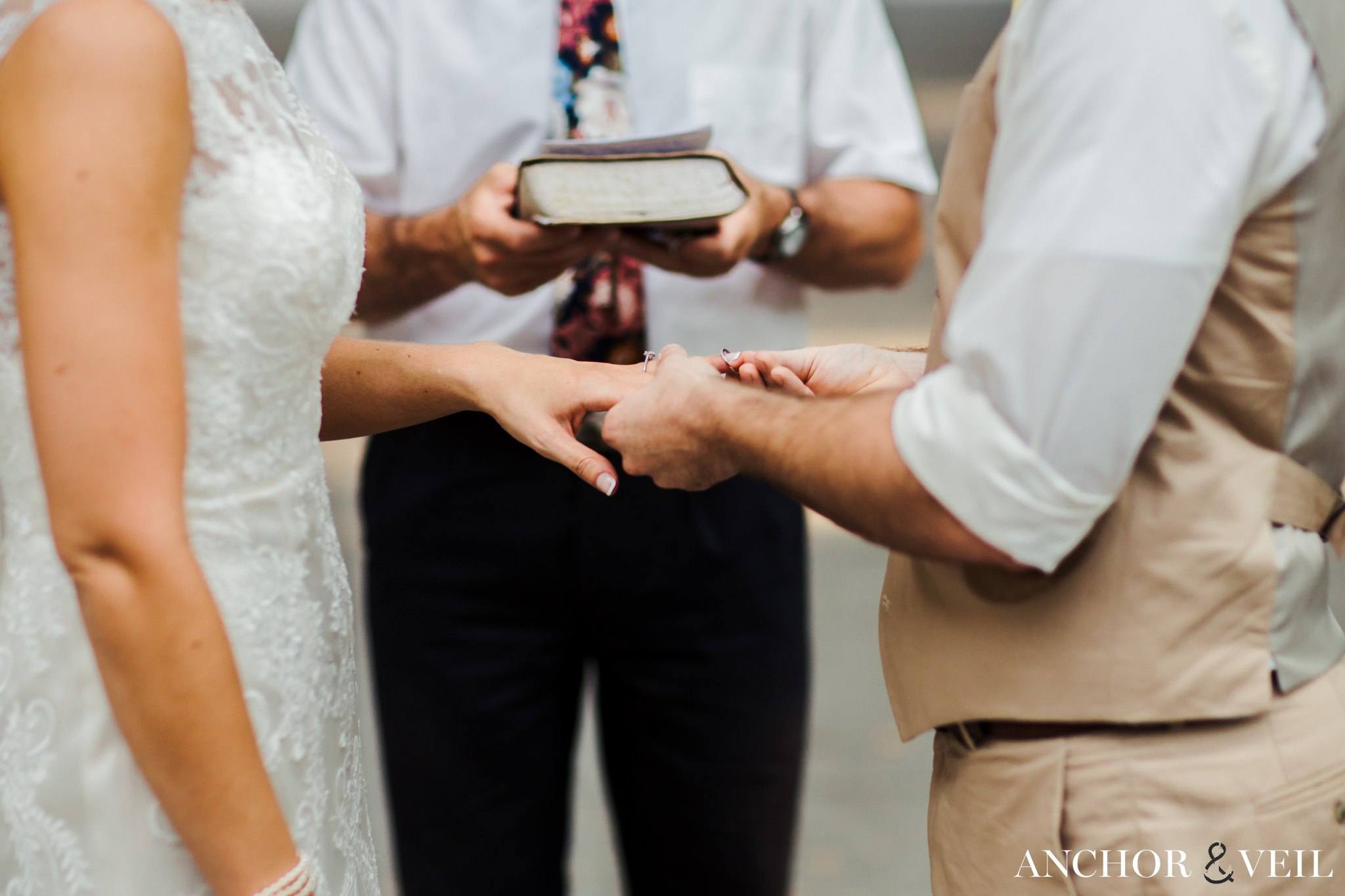 putting the ring on the brides hand during their Forsyth Park Wedding Elopement