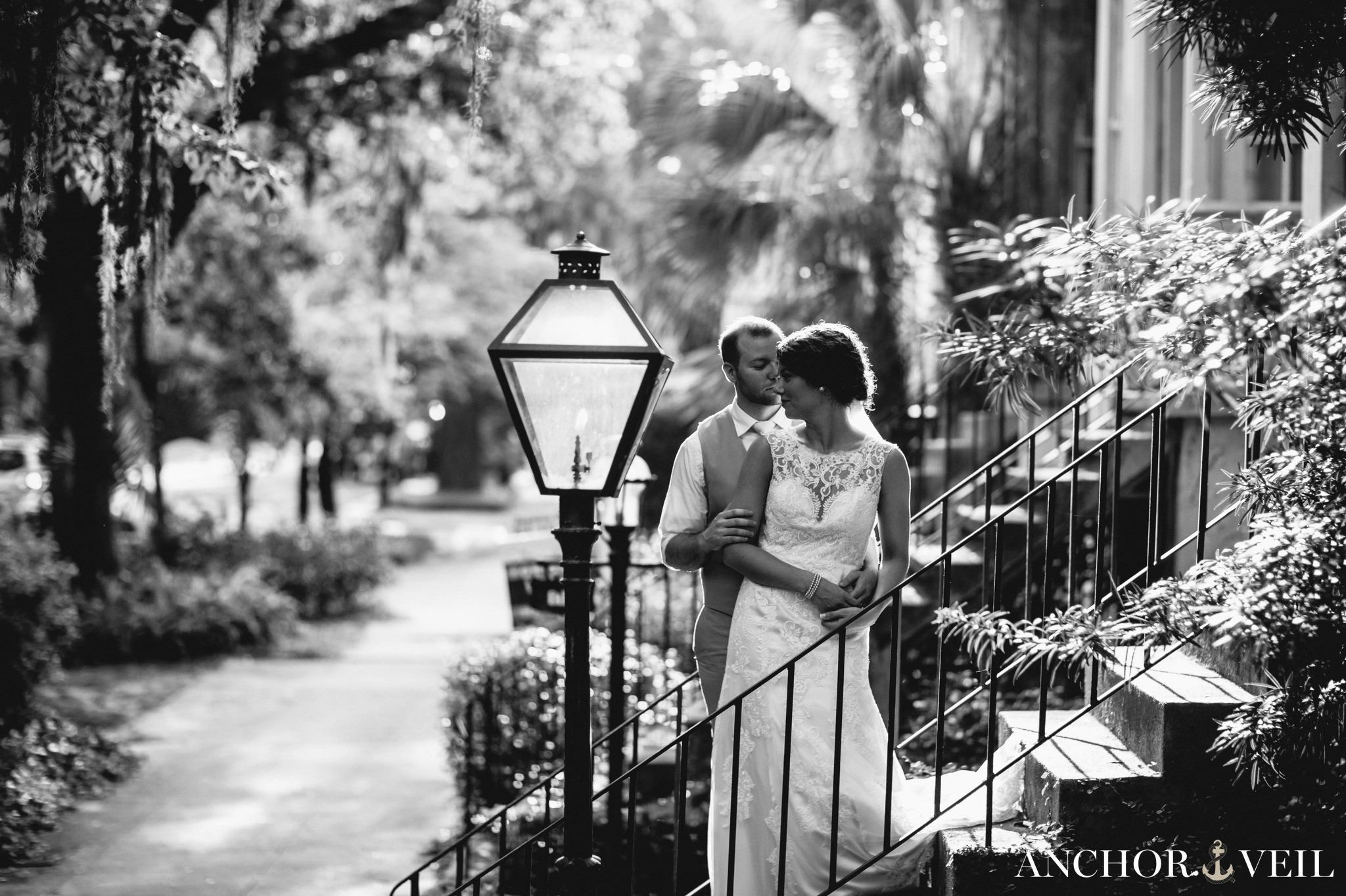 on the porch of a house in black and white with good light during their Forsyth Park Wedding Elopement