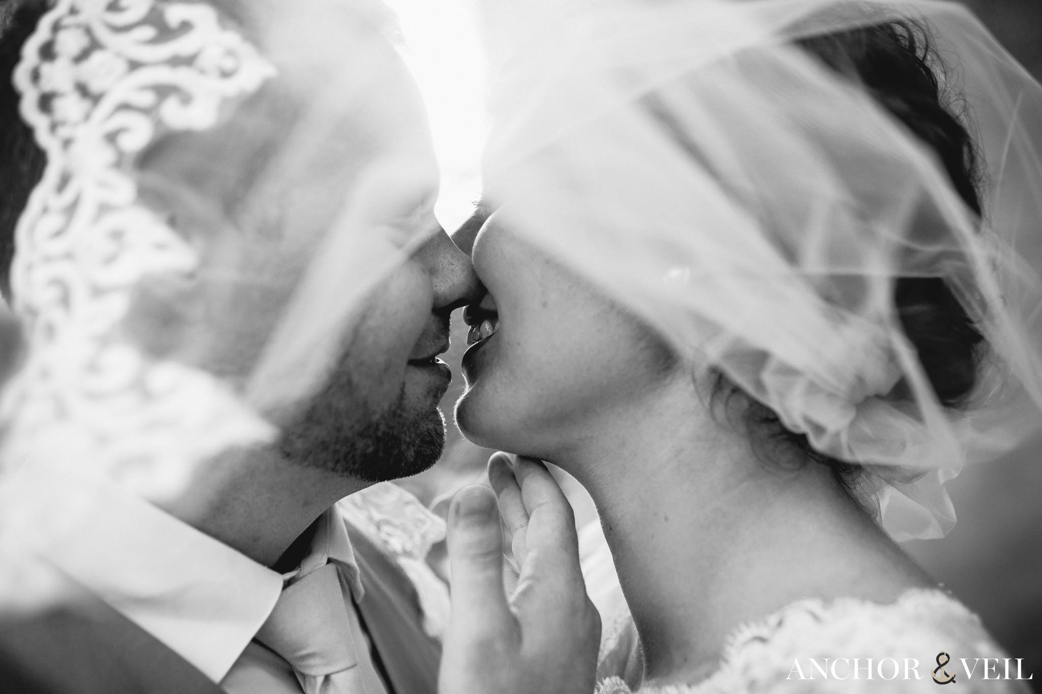 kissing under the veil during their Forsyth Park Wedding Elopement
