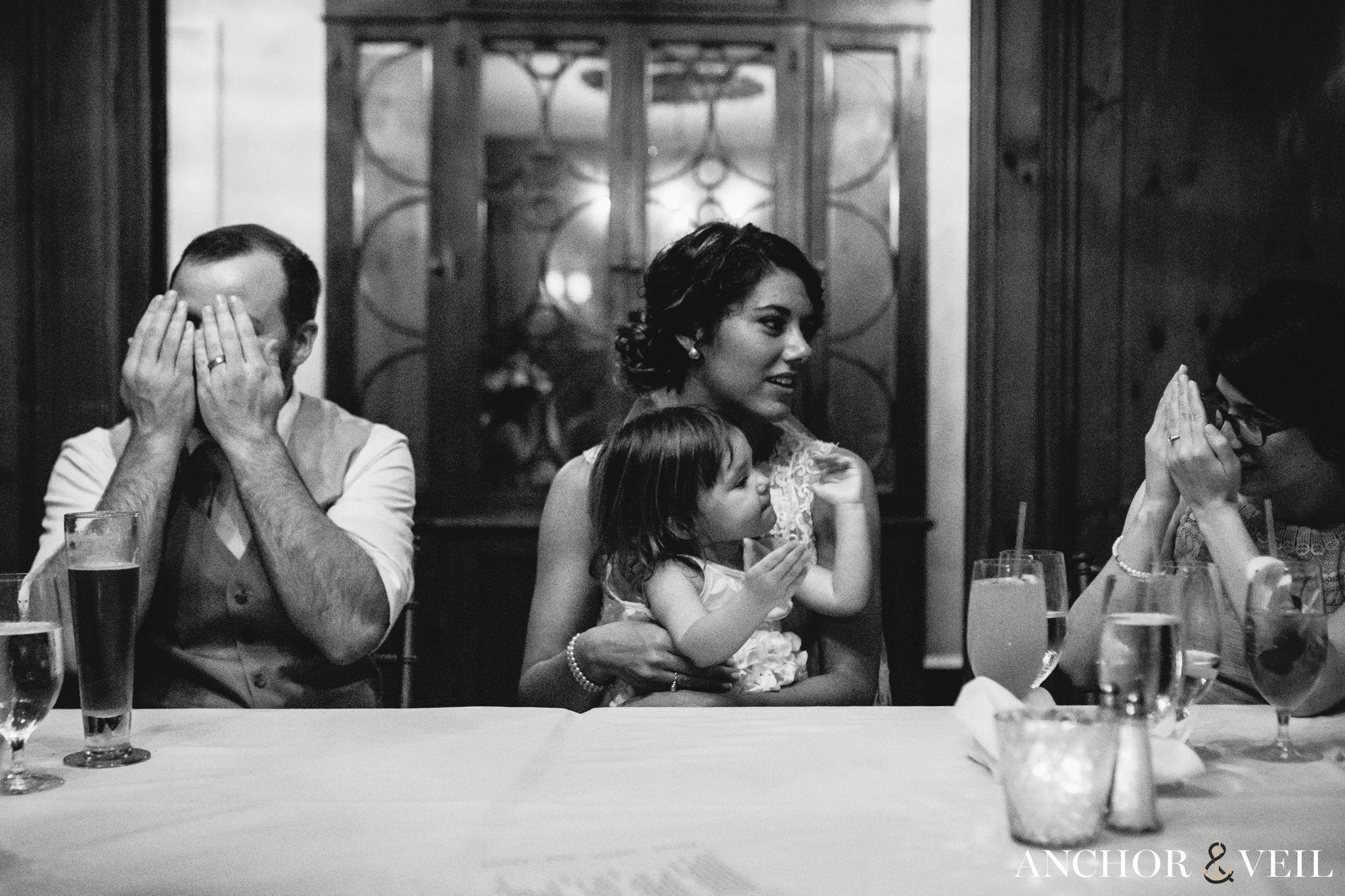 black and white photograph with the family playing peek-a-boo during their Forsyth Park Wedding Elopement