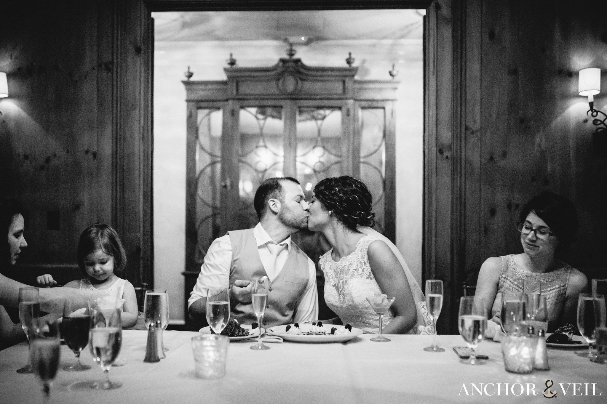 kissing in restaurant during their Forsyth Park Wedding Elopement