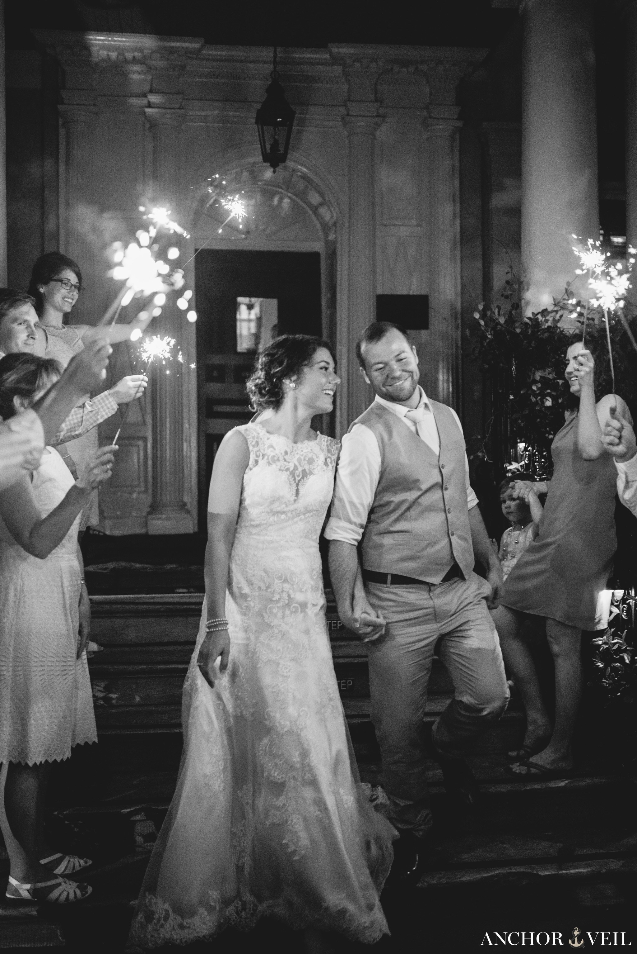 sparkler exit out of the pink house during their Forsyth Park Wedding Elopement